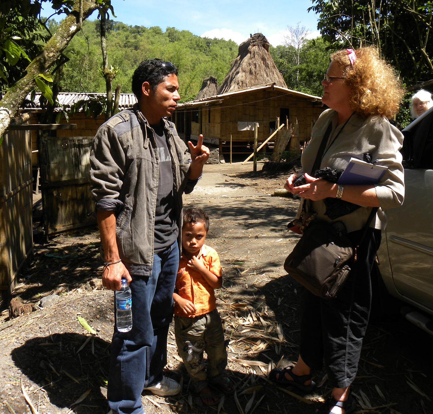 Barbara Rieke Turner and a translator discuss the art of a village in a remote area of Flores, Indonesia. (Photo courtesy Kim Hammer)