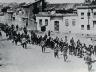 Armenian civilians, escorted by armed Ottoman soldiers, are marched through Harput to a prison in the nearby Mezireh, April 1915.