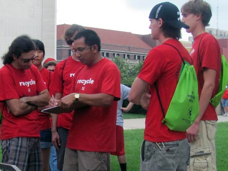 Prabs Shrestha (center), a recycling coordinator for UNL, guides volunteers during a Husker football gameday recycling effort. (Courtesy photo)