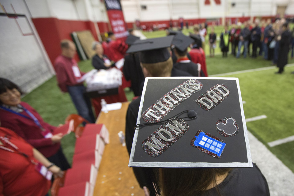 Mallory Miller of Council Bluffs, IA, has a special note for her parents across her mortar board as she waits to pick up her diploma form the College of Journalism and Mass Communication. Photo by Craig Chandler / University Communications