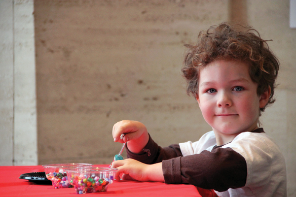 A child works with beads during a family day event at the Sheldon Museum of Art. (Nobuyuki Takahashi, Sheldon Museum of Art)