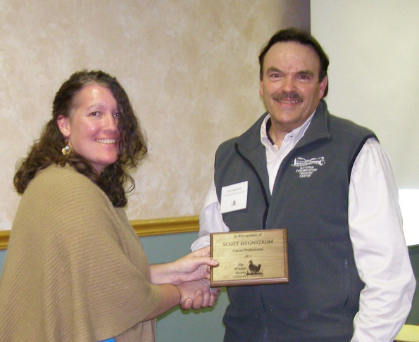 Teresa  Zimmerman Frink awards Scott Hygnstrom with a Career Award from the Nebraska Chapter of The Wildlife Society. 