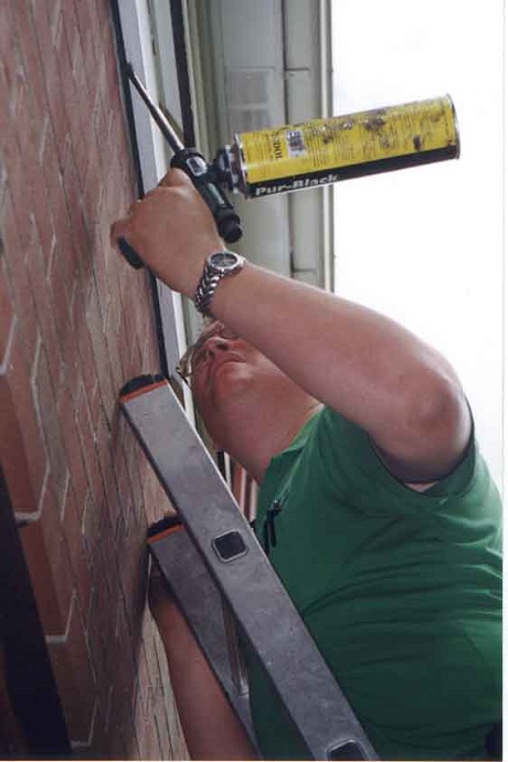 Stephen Vantassel applying bat foam to the exterior of a house. (Courtesy photo)