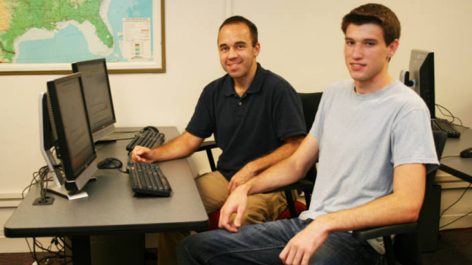 Fabio Mattos (at left), assistant professor of agricultural economics, and Lee Sabata, a senior agricultural economics major from David City, work in a computer lab in Filley Hall that will soon be transformed into a state-of-the-art agricultural commodit