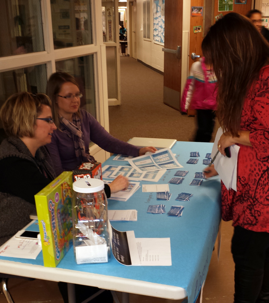 Angie Roby and Katie Keasling talk to a parent about math.