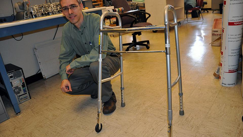 Carl Nelson displays a walker device that finished among the top devices entered in the 2014 Design of Medical Devices Conference "Three-in-five" competition.