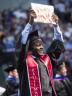 LeRoy Ford holds up his diploma for his family and friends to see.  (Photo courtesy of  Craig Chandler | University Communications)
