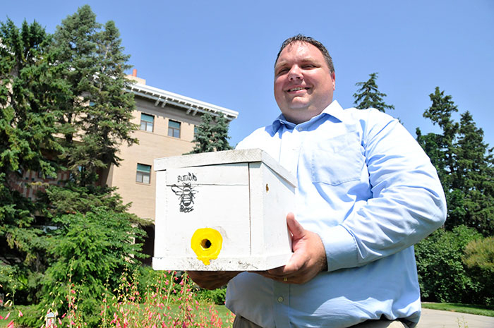 UNL's Doug Golick holds one of the bumblebee domiciles he placed on East Campus (Troy Fedderson | University Communications)