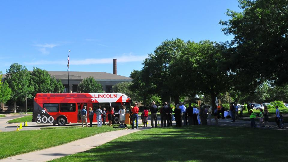 A crowd listens as civic leaders announce the addition of five new StarTran buses that will run on compressed natural gas. The buses will run on the two routes that serve UNL. (Troy Fedderson | University Communications)