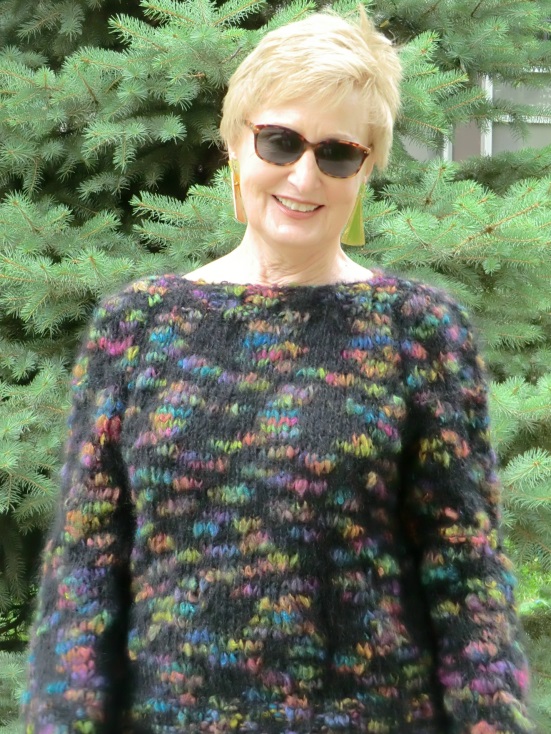 Kandra Hahn, modeling knitted sweater with materials purchased from previous textile sale for under $10.