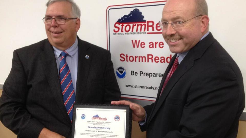UNLPD Chief Owen Yardley (right) accepts the StormReady certification from Brian Smith, warning coordination meteorologist with the National Weather Service, on Aug. 12. (Courtesy photo)