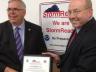 UNLPD Chief Owen Yardley (right) accepts the StormReady certification from Brian Smith, warning coordination meteorologist with the National Weather Service, on Aug. 12. The certification was earned through a year-long review of UNL's severe weather alert