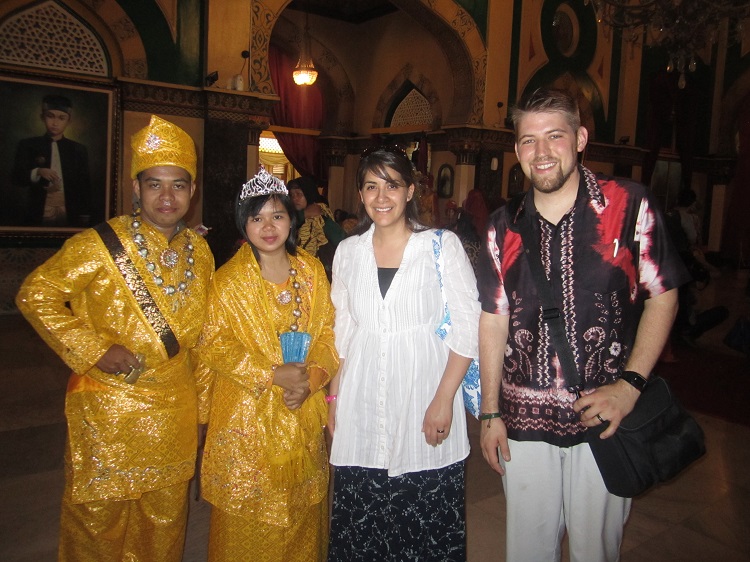 Derrick Meier with his wife and two Indonesian locals dressed in traditional clothing. (Courtesy photo)