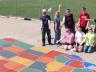UNL students who are part of the Geography Student Organization pose by the nearly complete U.S. map painted on a Scribner-Snyder Community Schools playground.