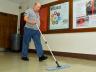 Bill Messman, a Custodial Services employee who has worked at UNL for 40 years, sweeps on the first floor in Canfield Administration Building on Sept. 15. (Troy Fedderson | University Communications)