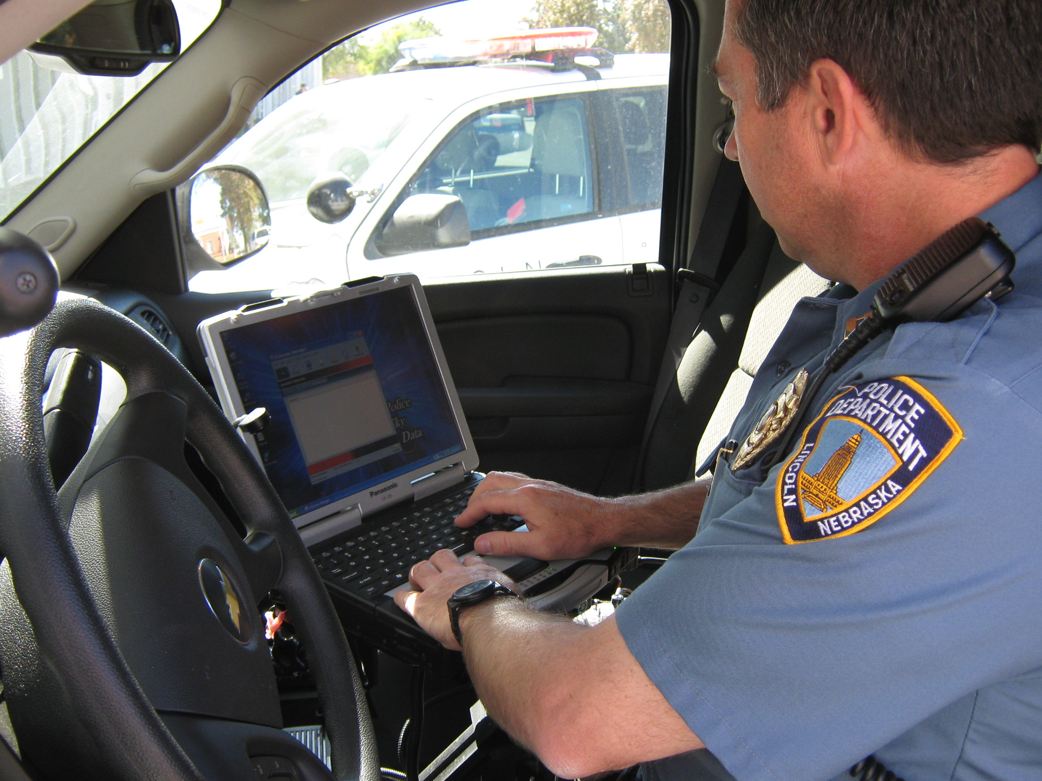 Captain Jim Davidsaver of the Lincoln Police Department uses the mobile data computer in his cruiser. UNL researchers are working with LPD to test smart phones and GPS-enabled laptops to improve patrol duties. 