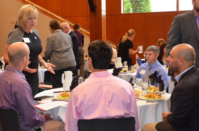 Dean Donde Plowman interacts with attendees at the Executive Power Lunch, “The Art and Science of Negotiation,” on September 3, 2014. 