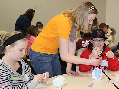 Pictured are 4-H'ers learning the single crochet stitch at the 2014 "Basic Crocheting" workshop.