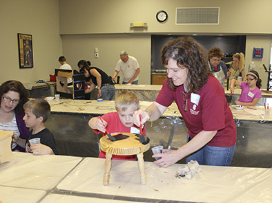 Pictured are 4-H'ers learning how to prepare wood furniture at the 2014 Furniture Painting workshop.