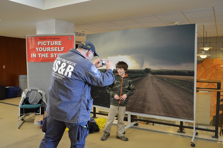 A Weatherfest attendee gets his picture taken with a tornado image at the 2014 event. (Mekita Rivas | Natural Resources)