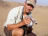 Richard Reading, vice president for conservation biology at the Denver Zoo, holds a vulture during a research trip to Africa. Reading will talk at UNL on May 6. (Courtesy photo)