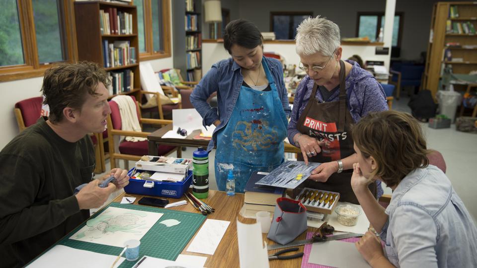 Cather Professor of Art Karen Kunc discusses a printmaking techique with students enrolled in the Art at Cedar Point course. The new summer course is held at the UNL's Cedar Point Biological Station and allows students to focus solely on creating art for 