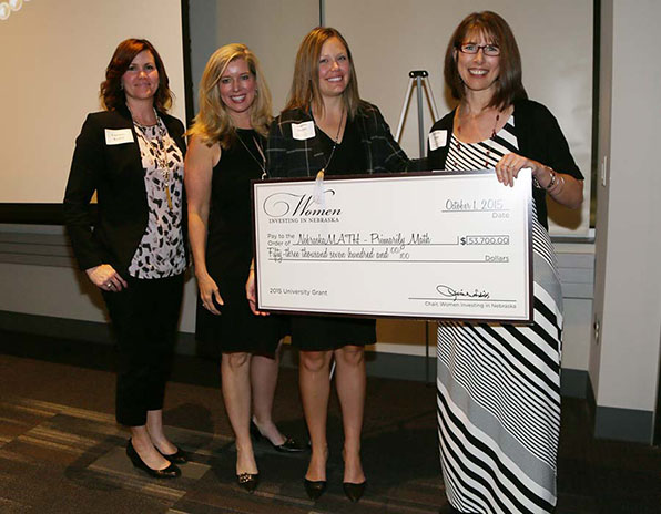 Michelle Homp (right) receives the WIN award in 2015.