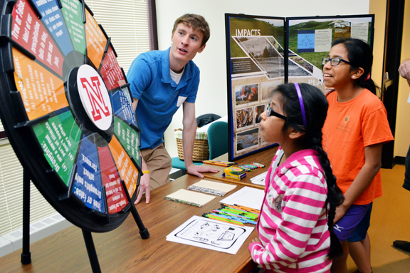 Claudia Carrillo (left) and Paula Carrillo learn about drought from Jake Petr, senior meteorology student at the School of Natural Resources, at the 16th annual Weatherfest and Central Plains Severe Weather Symposium on Saturday, April 16, 2016, at Hardin