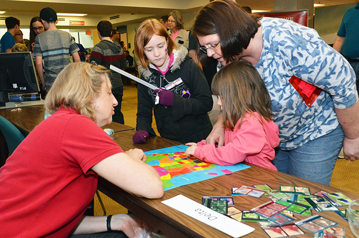 From left, Zoe Fischer, Emmalyn Smith, 3, and Vicki Cotton, all of Lincoln, participate in the How Well Do You Know Your World booth at the 16th annual Weatherfest and Central Plains Severe Weather Symposium on Saturday, April 16, 2016, at Hardin Hall on 