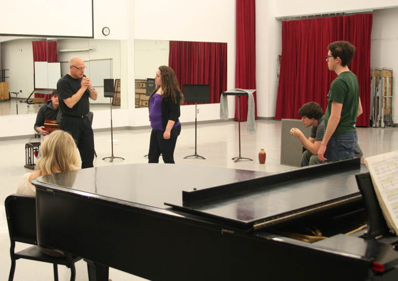 William Shomos works with students at a rehearsal for "Amahl and the Night Visitors."