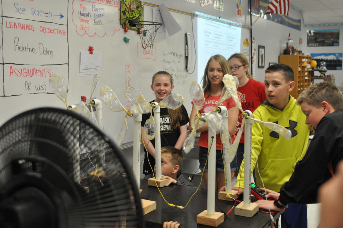 Beatrice Middle School sixth graders watch their handmade wind turbine models in action as a fan flows air at them. (Annie Bohling, Beatrice Daily Sun staff)