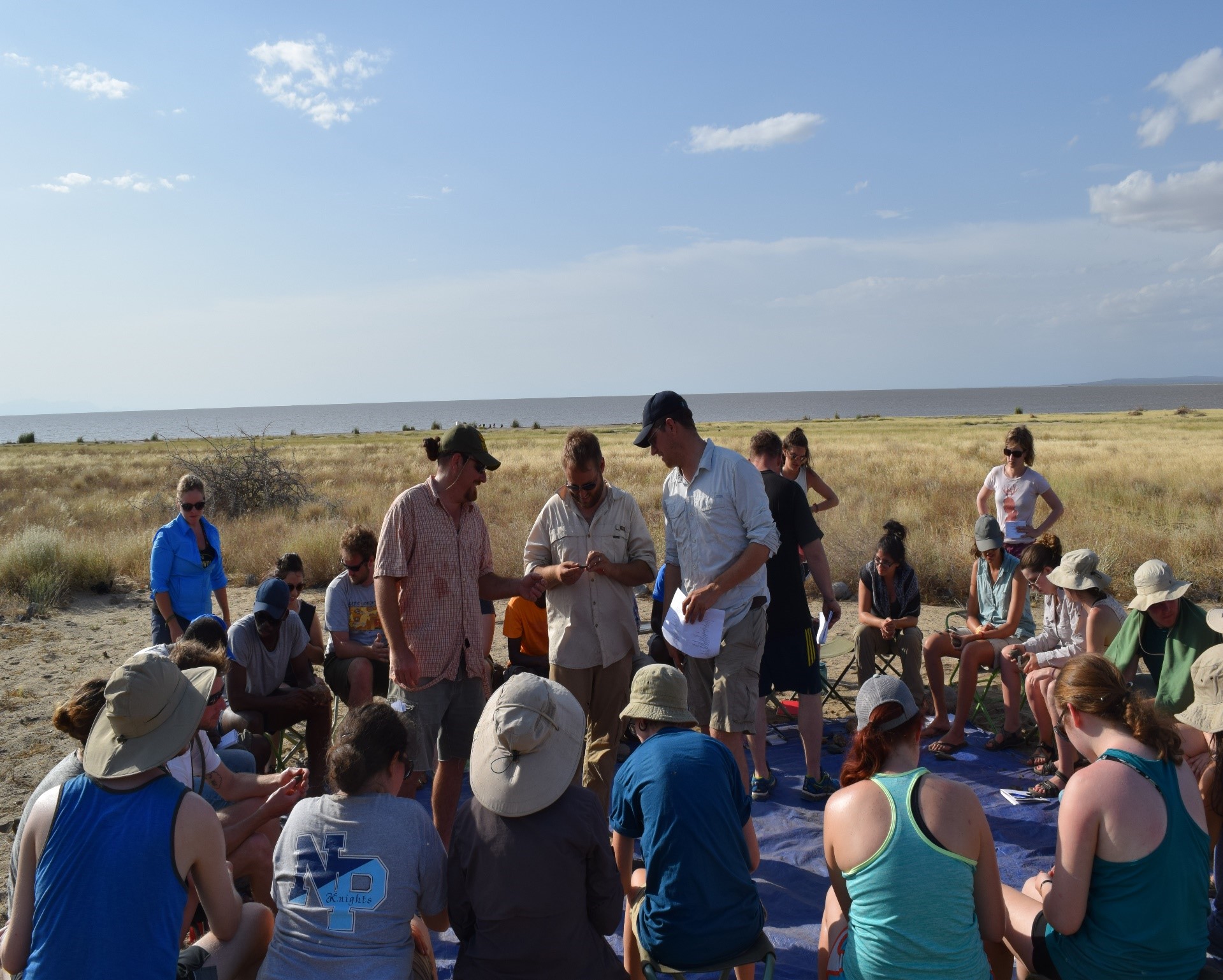 Douglass (center), Jon Reeves (right) and David Braun (back) (George Washington), and Russell Cutts (left) (Univ. of Georgia) instruct students from US and African Universities in stone artifact identification at the Koobi Fora Base Camp on the east shore