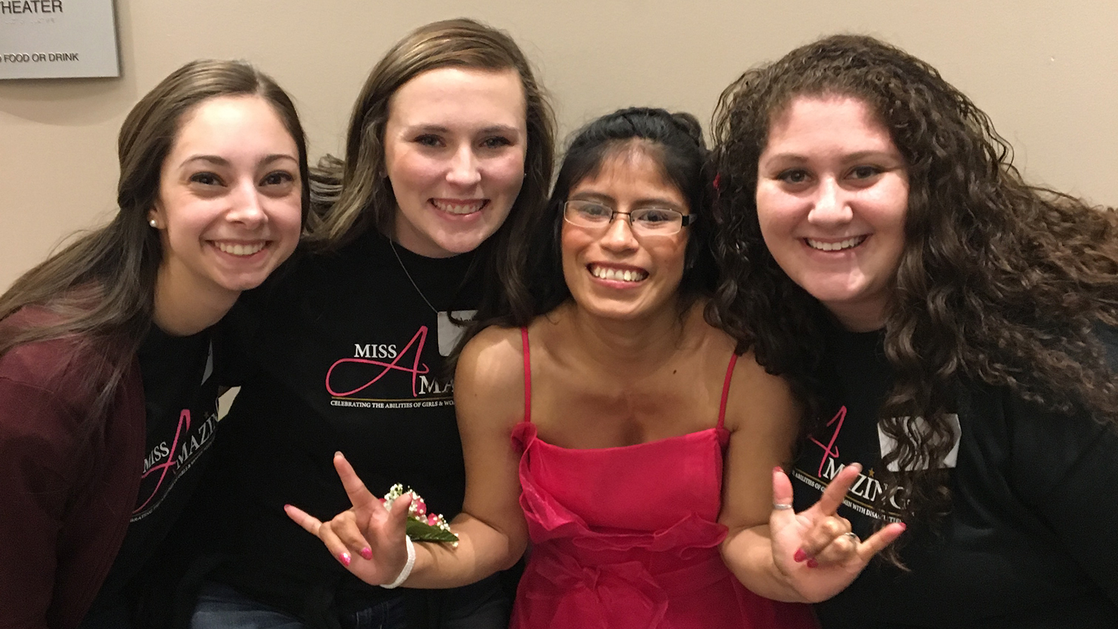 UNL seniors Stefanie Gentile, Hayley Brooks and Aly Lerman pose with Carmita Wilson after being paired with her at the 2016 Iowa Miss Amazing Pageant.
