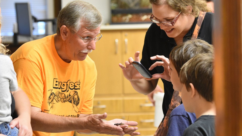 Entomology Professor Fred Baxendale introduces Vinnie the vinegaroon to a BugFest guest in 2015. | Tom Weissling, Department of Entomology