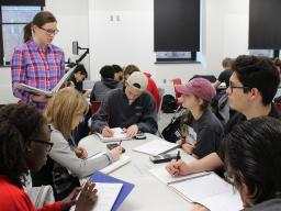 Undergraduate learning assistant Meredith Hovis (left), a secondary mathematics (6-12) major, facilitates group discussions with students in a Math 101 course. 