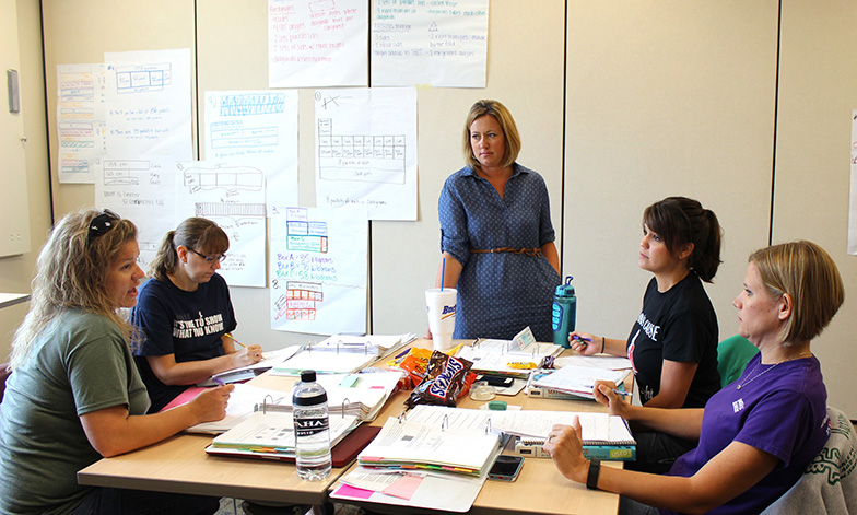 Master teacher Marni Driessen of OPS (center) works with Primarily Math teachers.