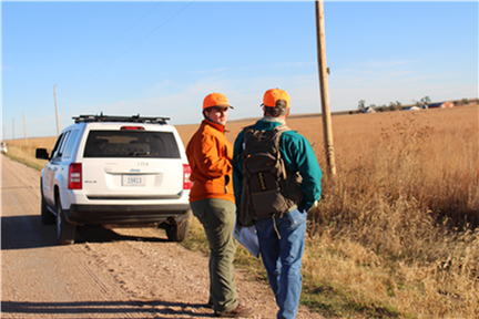 University of Nebraska graduate student Lyndsie Wszola talks to a pheasant hunter about why tracking hunter movements is important to pheasant management. │ Caitlyn Gillespie, courtesy