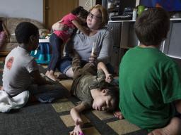 Nora Boesem feeds her son A.J. through a feeding tube at their house in Newell, South Dakota.