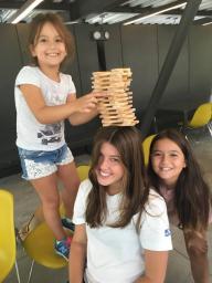 CoJMC student Azlin Armstrong (center) enjoys a game of Jenga with her campers in Istanbul, Turkey.