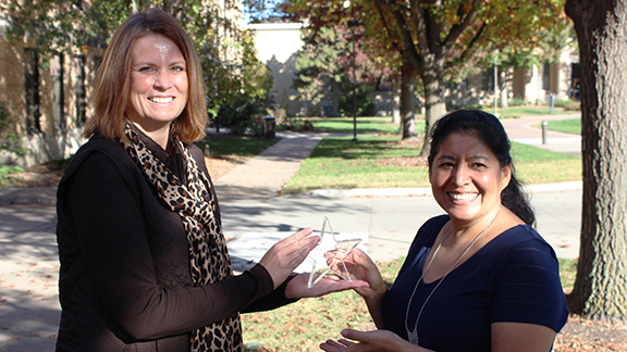 Catia Guerrero (right) is presented the Star Award from Staff Council co-chair Nancy McConkey.