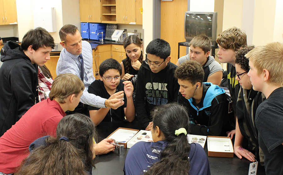 MAst graduate Tony DeGrand (back row, second from left) shows rocks and minerals to his students at Lincoln North Star High School. Lindsay Augustyn | UNL CSMCE