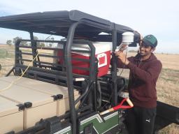 Visiting doctoral student Thigesh Vather works with the cosmic ray rover in western Nebraska, an ATV outfitted with probes that collect soil moisture data from the atmosphere. Vather and WFI Faculty Fellow Trenton Franz analyzed the probe’s soil moisture 