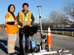 Dr. Jinying Zhu (left) with graduate student Hongbin Sun showing the cart rigged with the metal bead system.