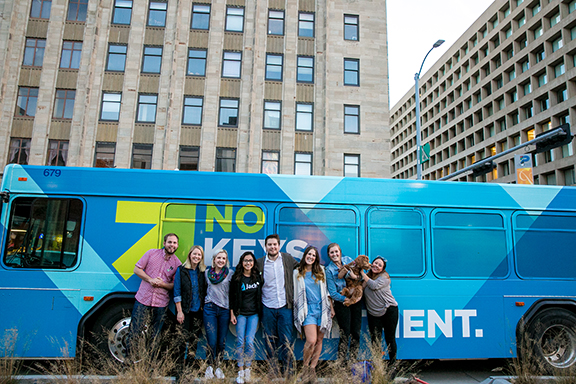 Graphic designers Collin Rasmussen (left), Alex Mabry (second from left) and Carlos Velasco (fifth from left) were among the members of the Jacht Ad Lab's Lincoln bus project team. Courtesy photo. 