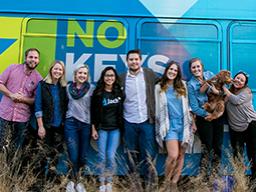 Members of the Jacht Ad Lab stand in front of their bus at the First Friday event in November that launched their rebranding of StarTran, Lincoln's bus system. The team included graphic designers Collin Rasmussen (left), Alex Mabry (second from left) and 