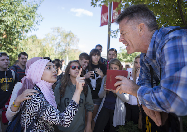 Kevin Pulver, right, from the Consuming Fire Fellowship, argues his religious beliefs with Zahraa Albusharif, a Muslim from Iraq, on Sept. 11, 2015, outside the Student Union at the University of Nebraska-Lincoln. Photo by James Wooldridge.