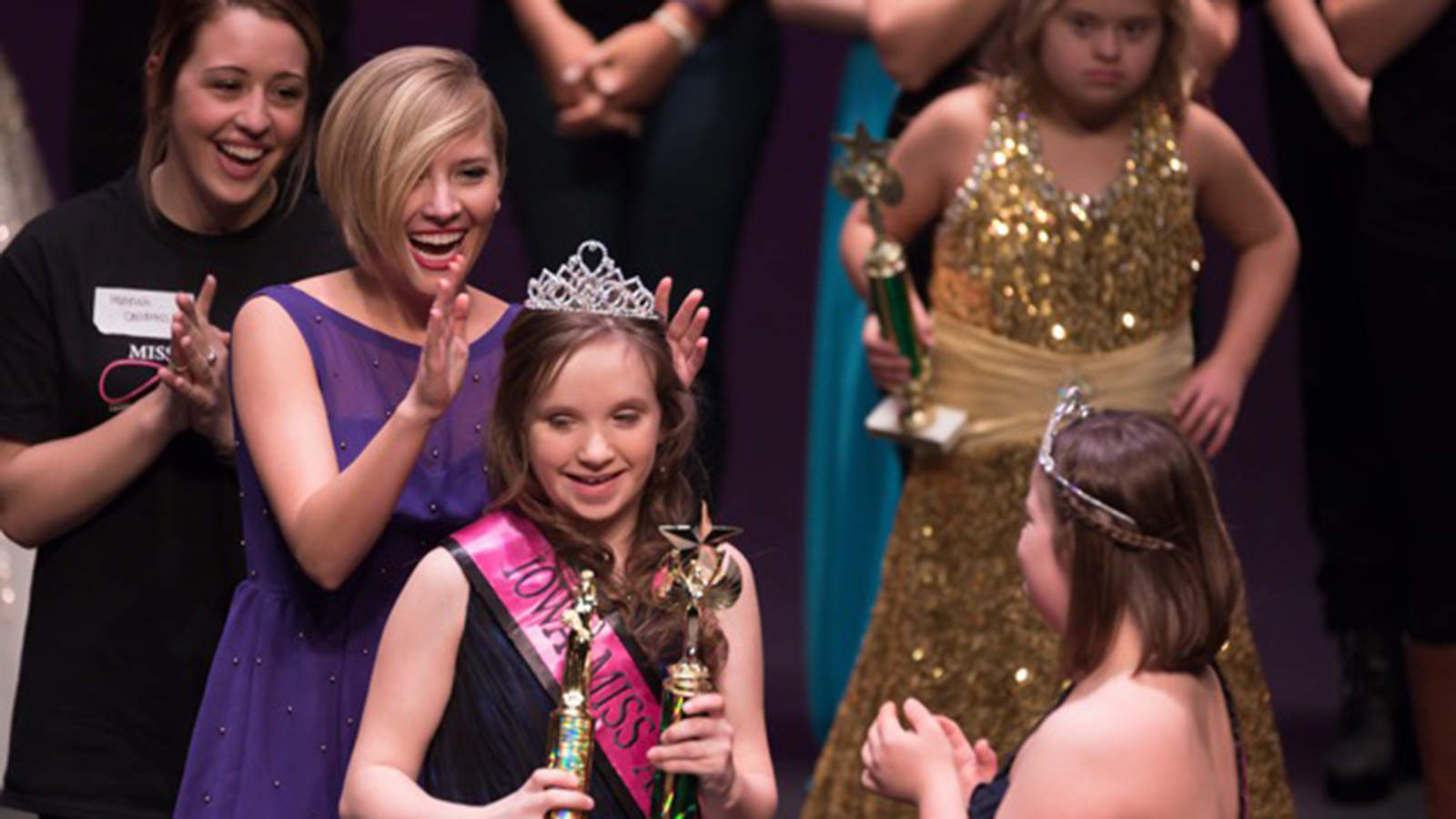 Maddie Lorenzen, a senior speech-language pathology major, crowns a queen at the Iowa Miss Amazing Pageant.