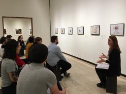 Students in the Nebraska Mosaic class listen as Abby Groth, assistant curator of public programs, (far right) discusses the nuances of Jim Lommasson’s exhibit at the Sheldon Art Museum. (Photo by Michelle Hassler)