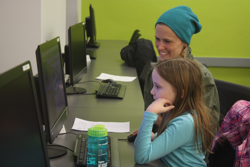 Mentor Gretchen Larsen helping LPS student, Brynn, develop her coding skills during the first CADDY workshop.