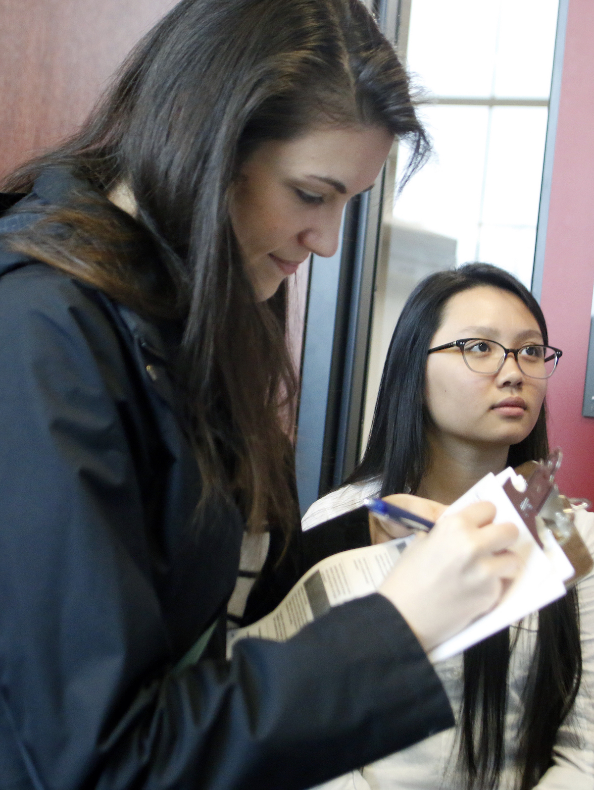 Erica Stuber, spatial ecologist with the School of Natural Resources, judges Ninian Tong's research poster on temperatures affecting cyanobacteria blooms. | Shawna Richter-Ryerson, Natural Resources